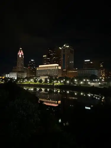 Skyline at night, perfectly mirrored in the river below.